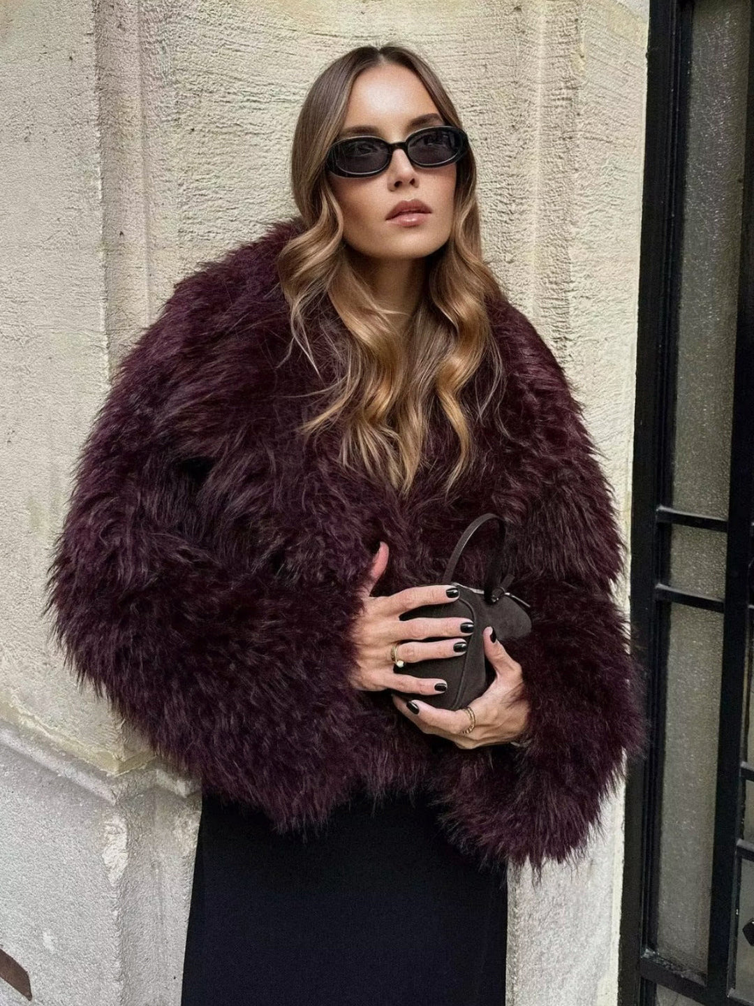Glamorous women's plush cropped jacket, a chic and fashionable outerwear statement for winter and evening wear.