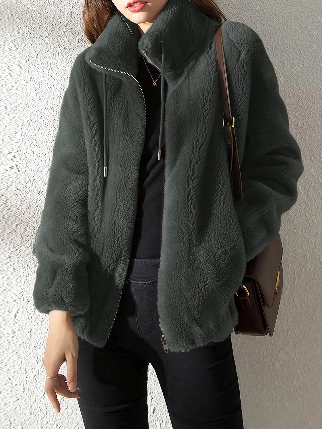 Stylish women's Isla teddy coat, featuring a soft plush texture, adjustable drawstring, and secure zipper.