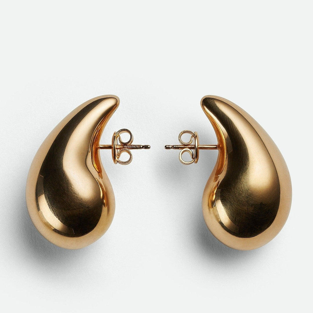 Minimalist polished teardrop dangle earrings. Versatile women's fashion jewelry in gold or silver.