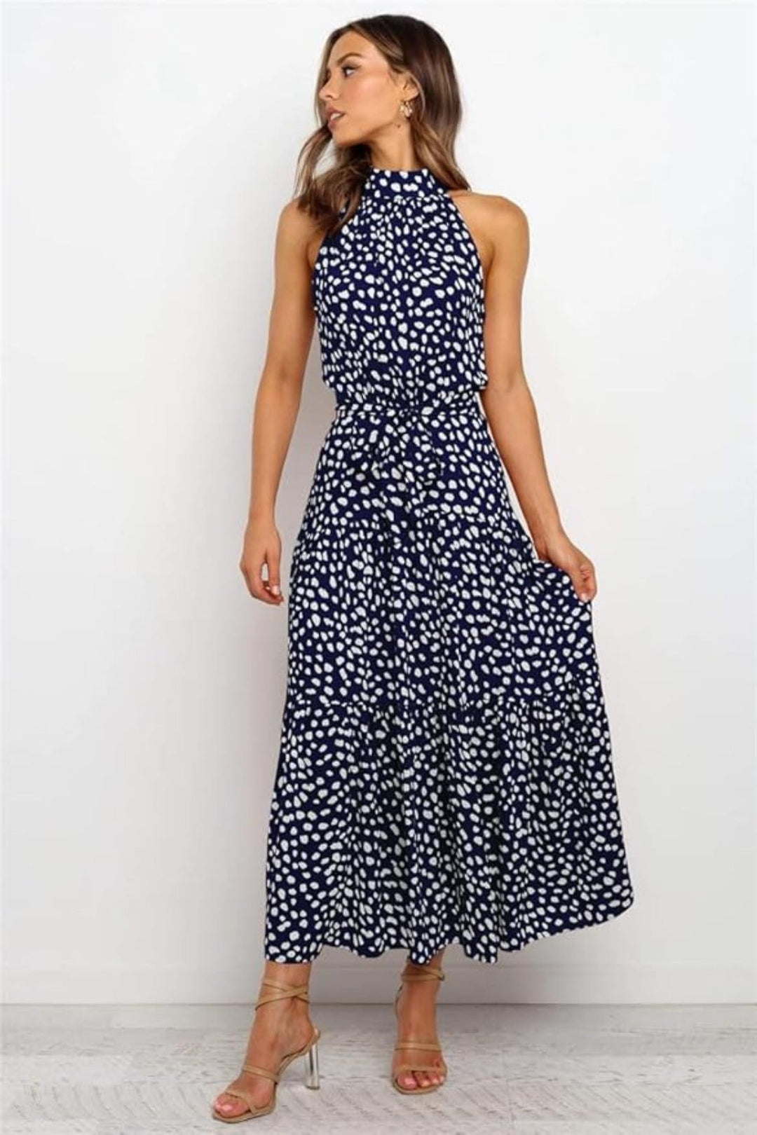Navy blue polka dot halter midi summer dress for women. Casual elegant daytime wear with a fit & flare style.