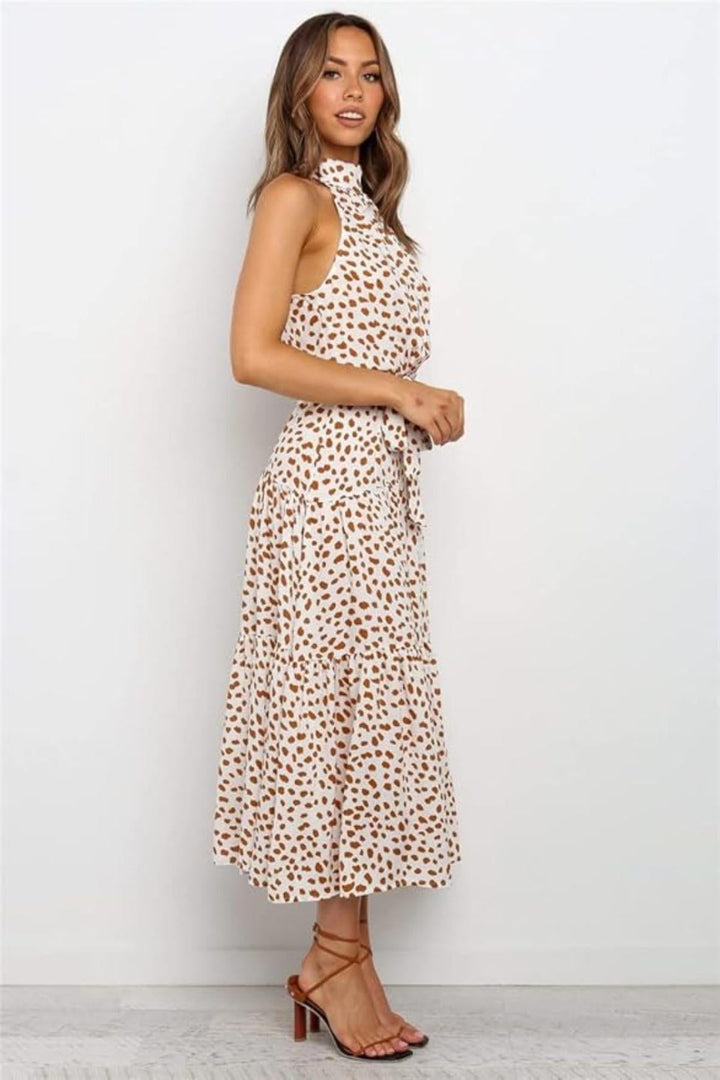 Polka dot pattern on a women's halter neck midi dress. Chic summer casual dress with a flattering fit & flare.