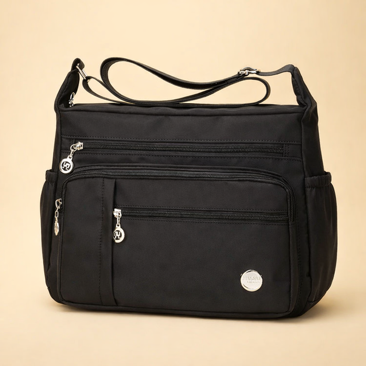 Stylish women's black crossbody travel bag. Practical multi-pocket design for everyday essentials & secure carry.