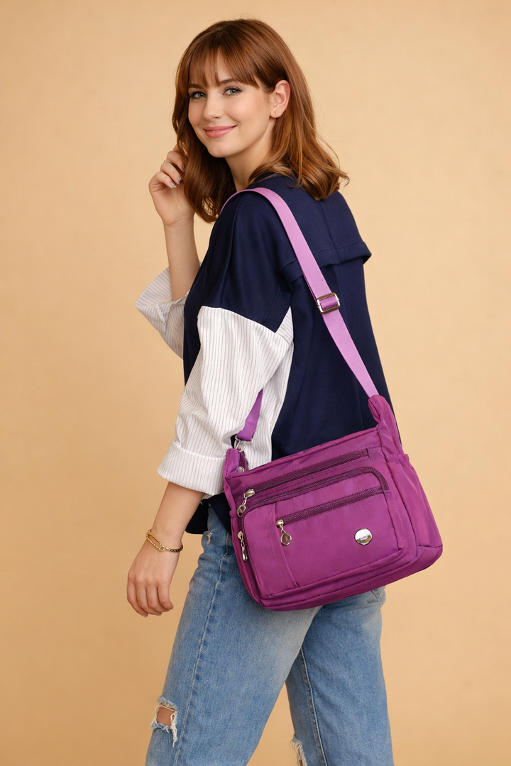 Elegant blue women's crossbody bag. Ideal practical travel handbag with secure multi-compartments for organization.