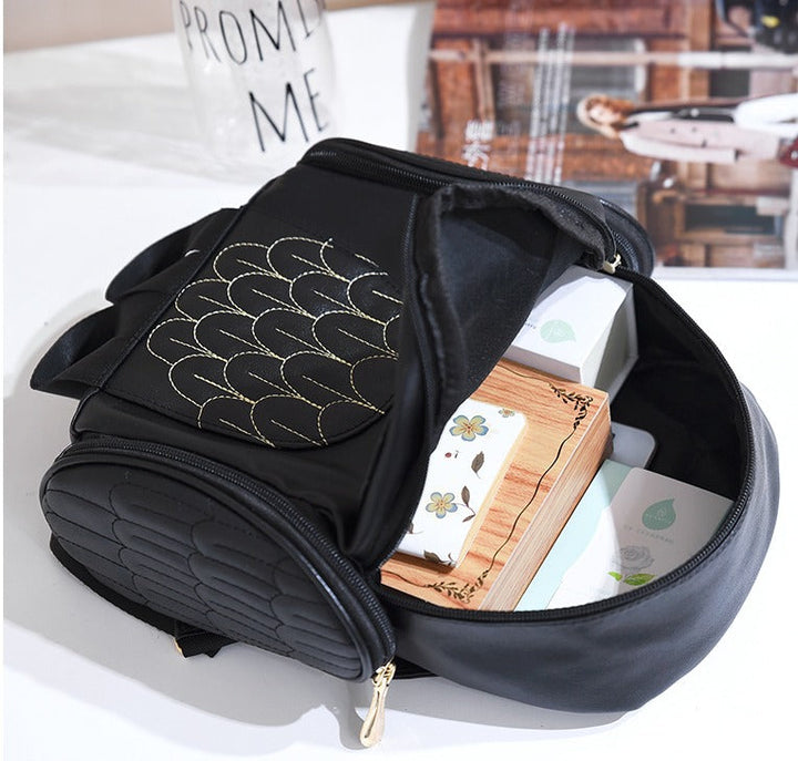 Spacious interior of a multi-pocket women's PU leather owl print fashion backpack for organized storage.