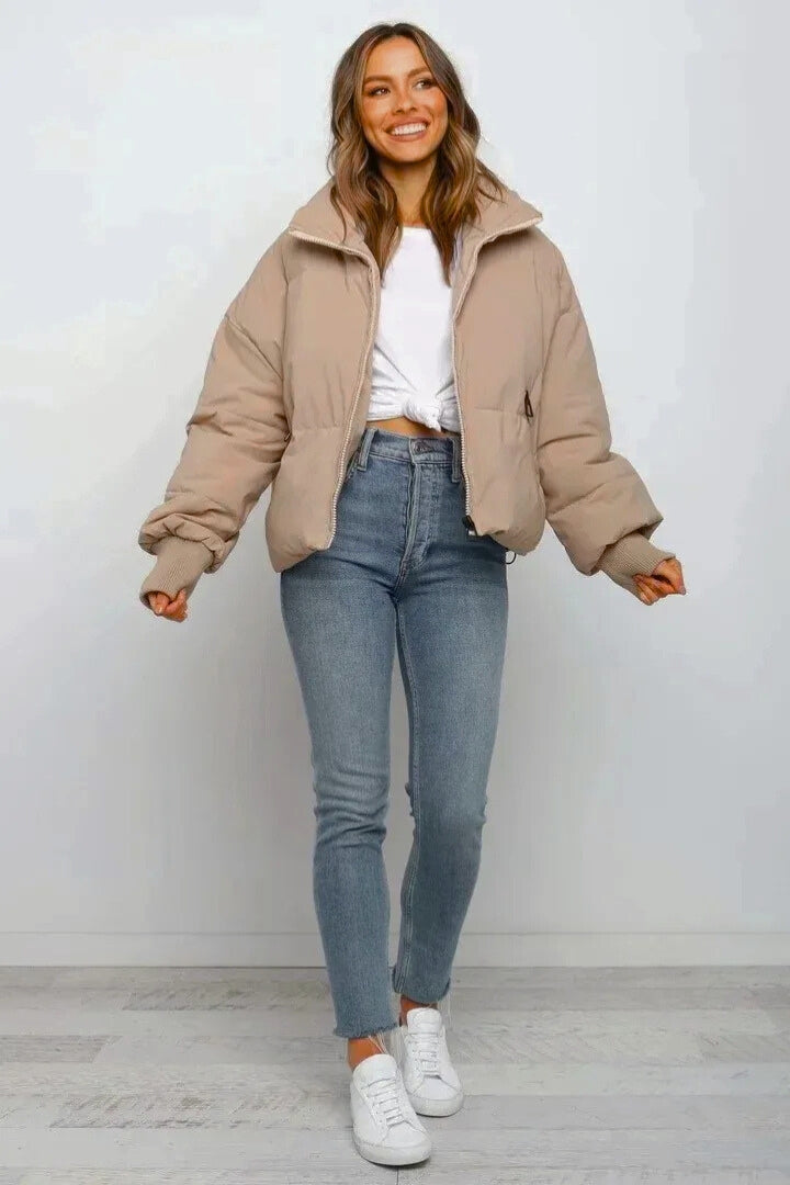 Model wears a women's short cropped quilted puffer jacket, perfect for stylish fall fashion & casual outings.
