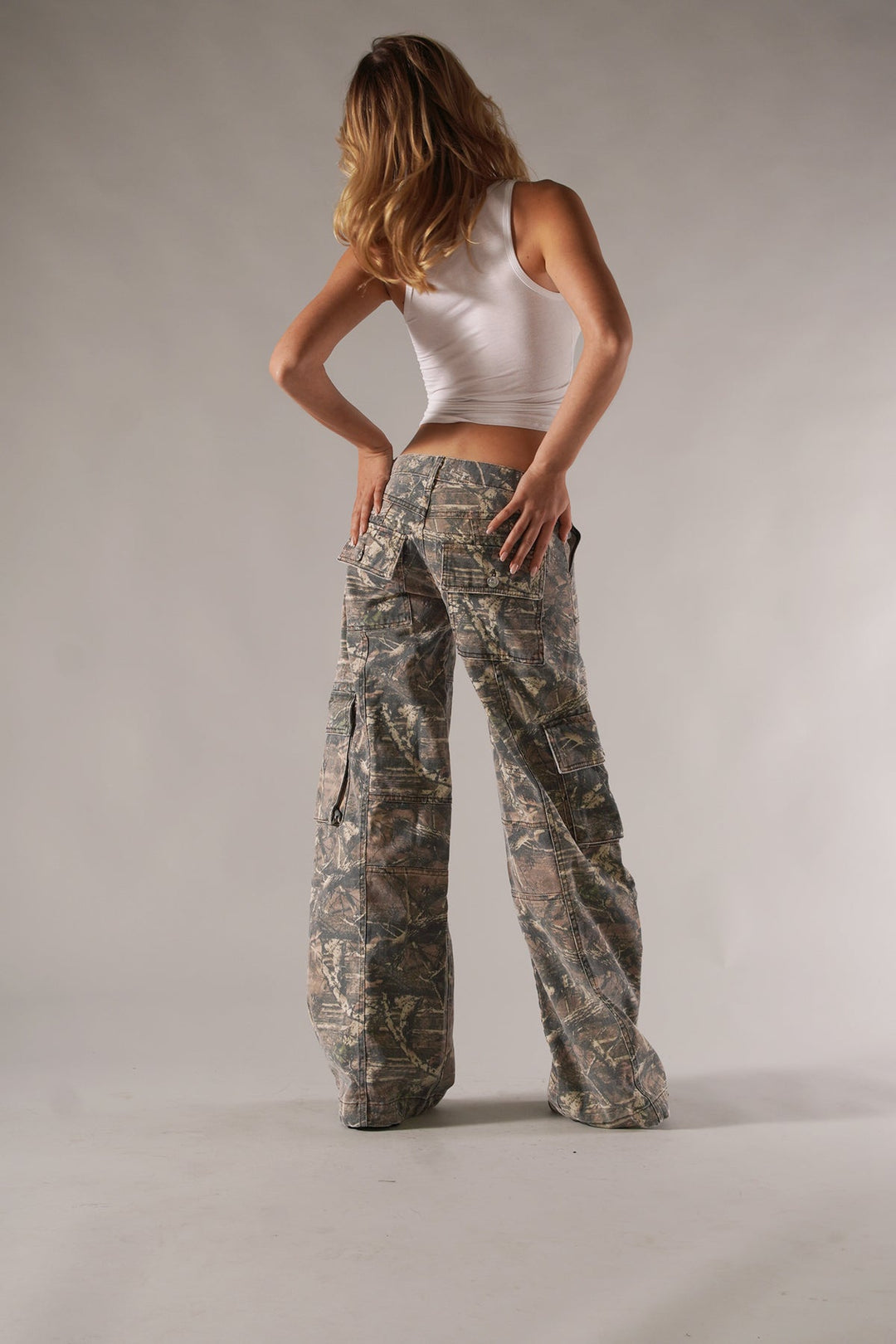 Utility-style women's camo cargo pants with relaxed fit, practical pockets, ideal for casual wear.
