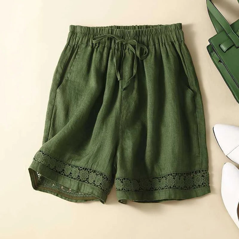 Chic green women's relaxed fit shorts featuring delicate embroidery, perfect for stylish summer looks.