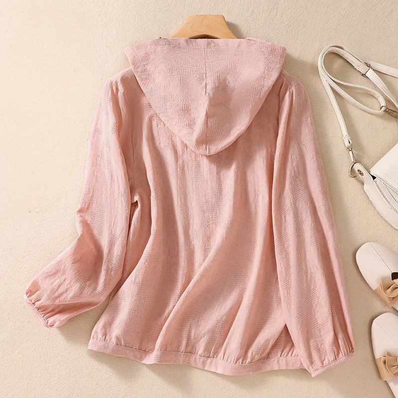 Woman wearing a relaxed fit long sleeve hooded shirt, showcasing its casual comfort and versatile style.