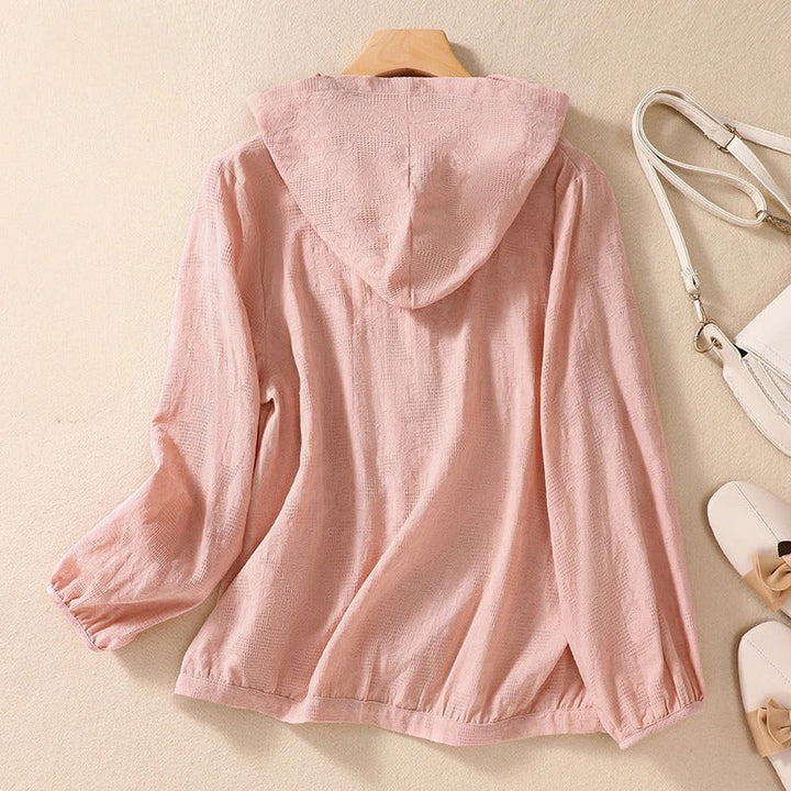 Woman wearing a relaxed fit long sleeve hooded shirt, showcasing its casual comfort and versatile style.