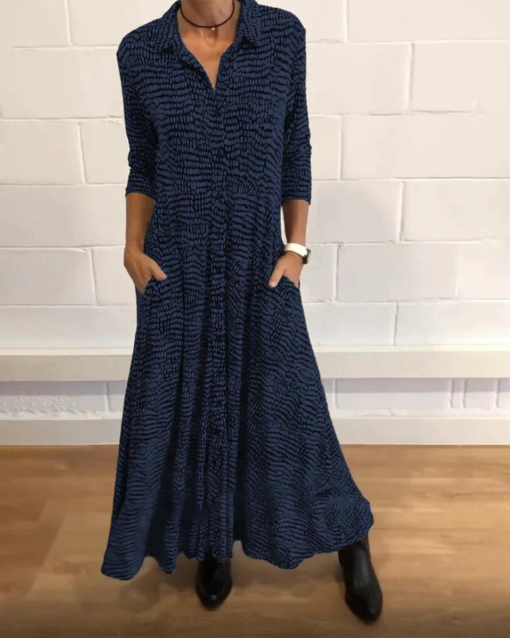 Relaxed fit women's maxi dress with V-neck, button-down front, and pockets; a comfortable, long casual dress.