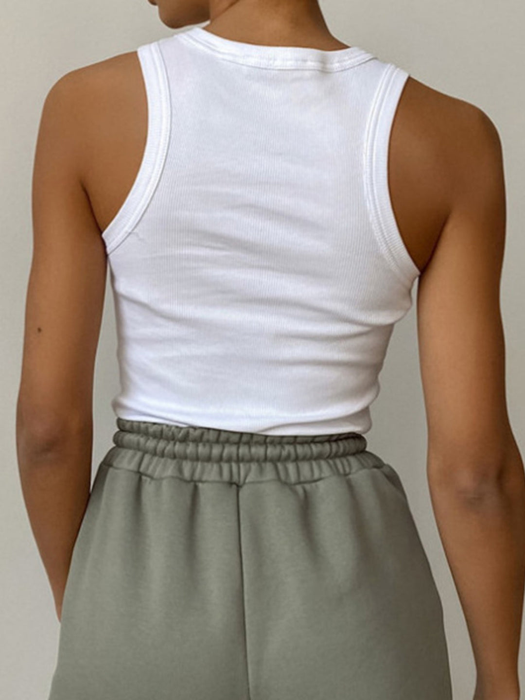 Fitted women's ribbed crop tank with high neckline, perfect for summer fashion layering.
