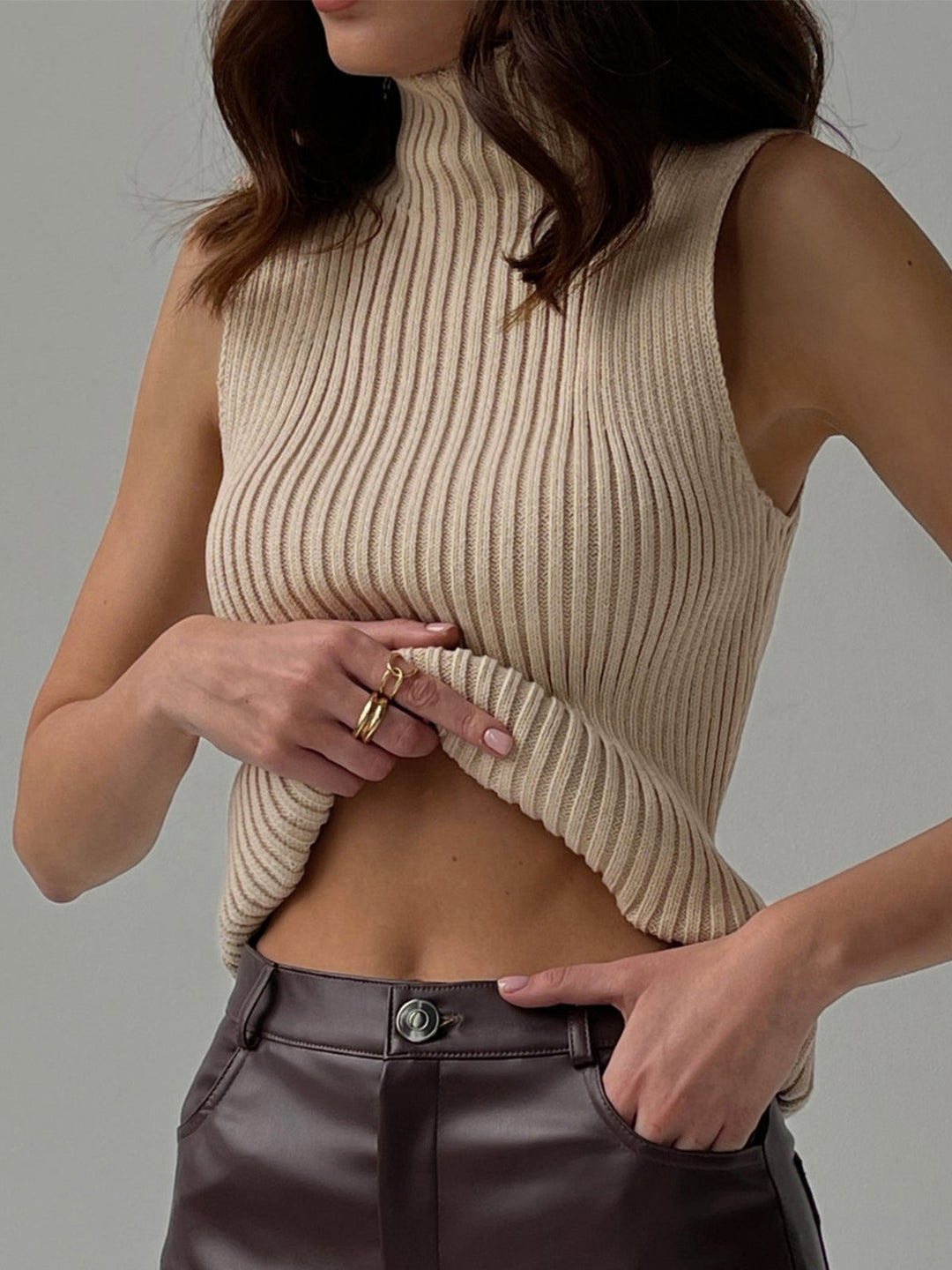 Women's ribbed mock neck sleeveless top in a chic, versatile style. Perfect for summer fashion.