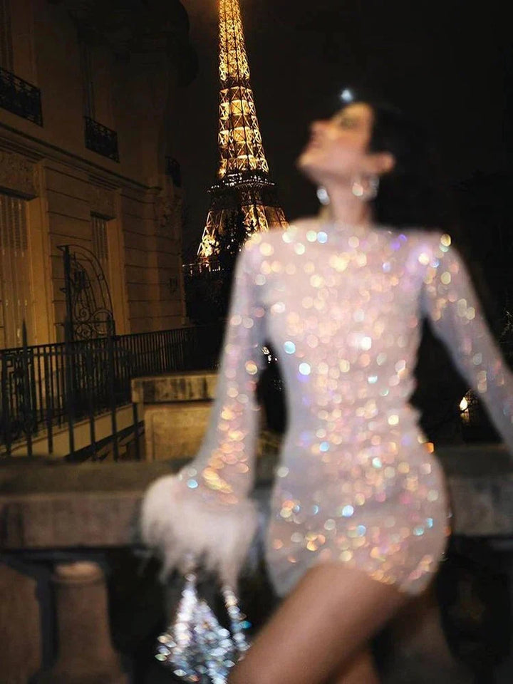 Back view of a women's metallic cocktail dress, showing the luxurious shimmer & flattering mini silhouette.