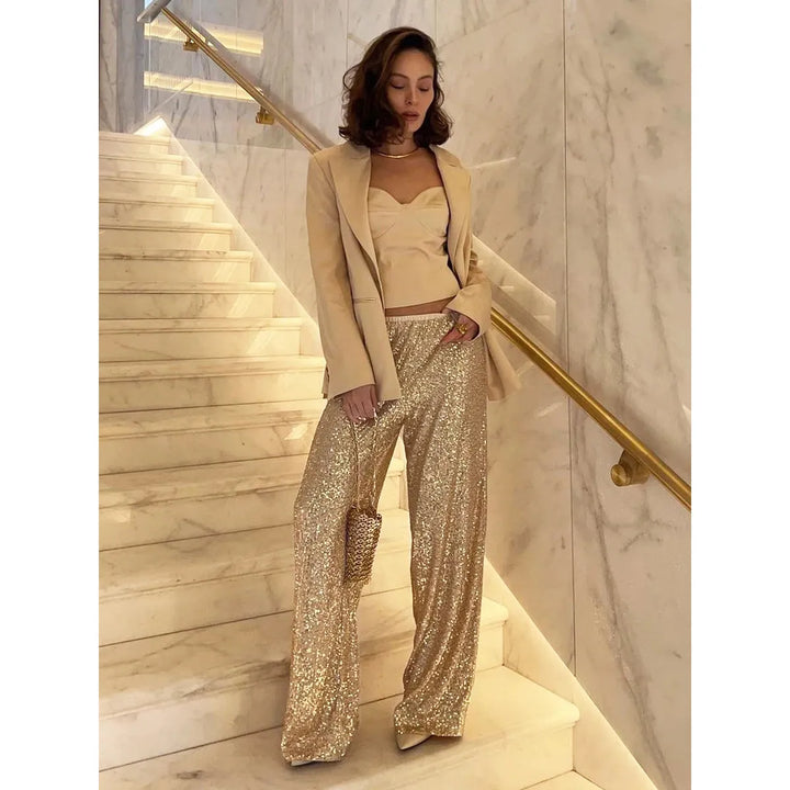 Glamorous women's shimmering sequin trousers. These festive party pants offer a dazzling metallic wide-leg look.