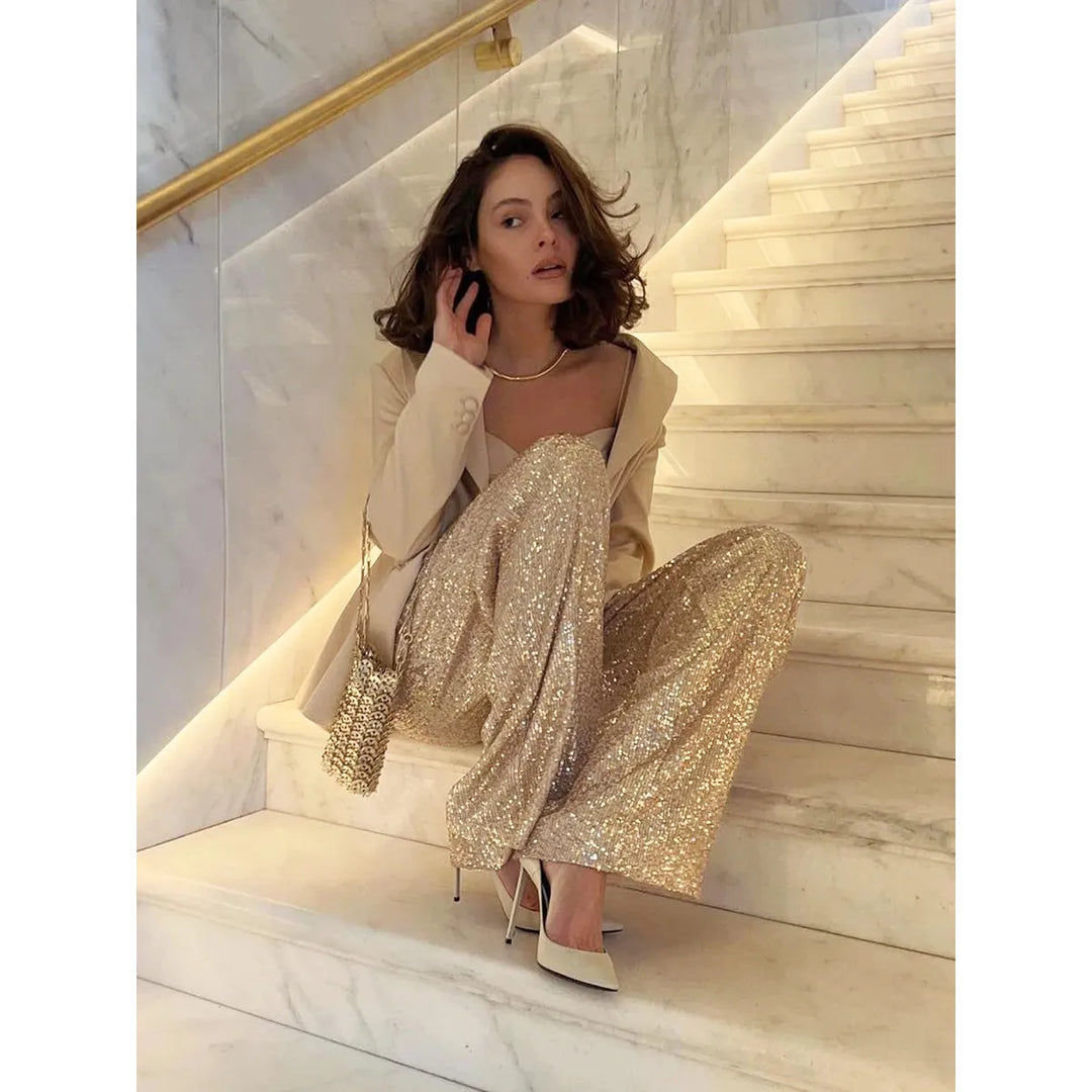 Women's sequin trousers for festive occasions. Shimmering, high-waisted, wide-leg party pants. Elegant evening wear.