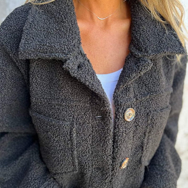 Women's short teddy jacket with a classic lapel collar, offering warmth and modern autumn style.