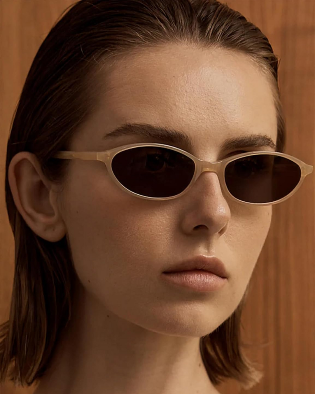 Women's sleek black oval sunglasses, perfect retro 90s fashion eyewear accessory.