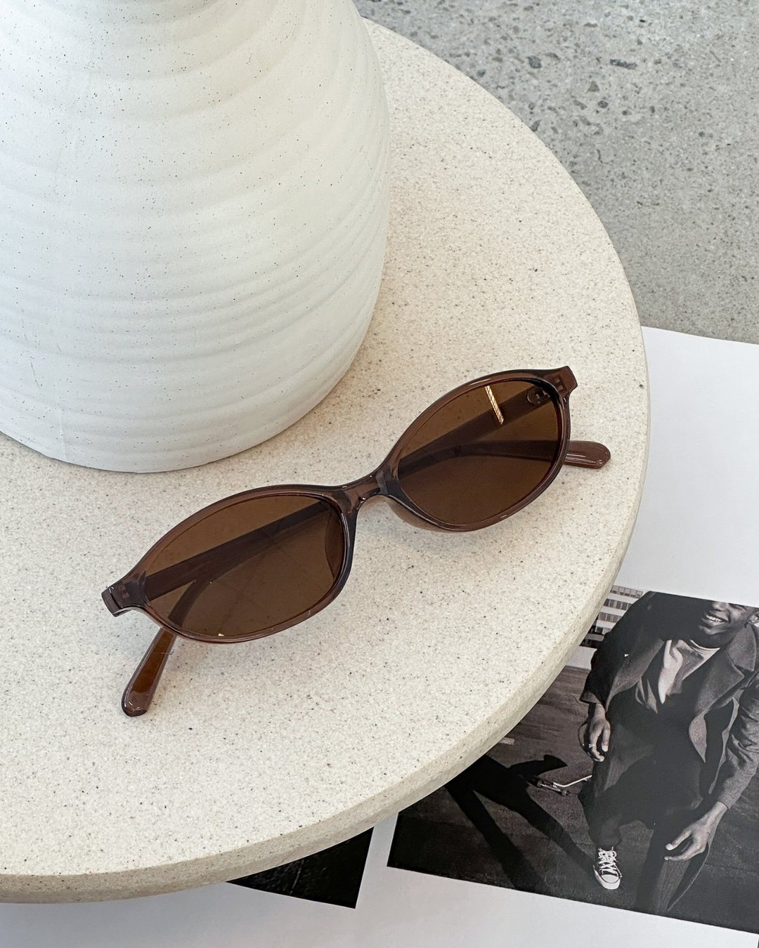 Lightweight women's oval sunglasses with a minimalist design, a chic fashion accessory.