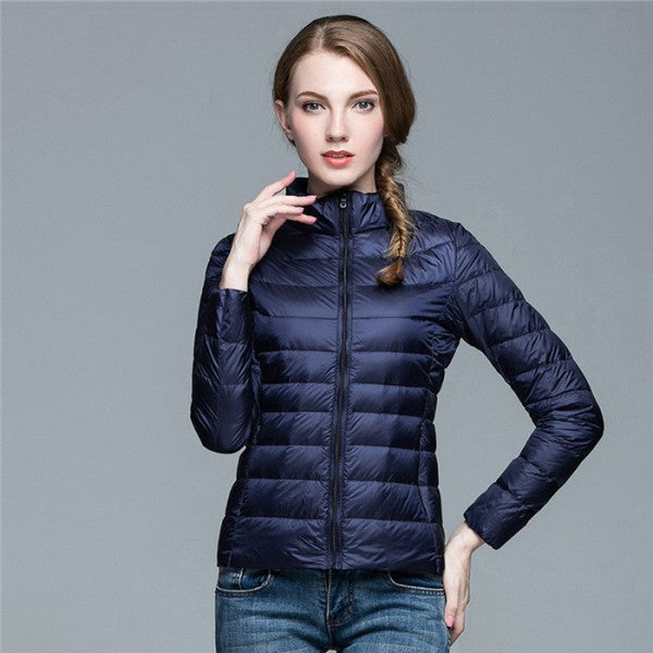 Women's sleek black quilted puffer jacket with a stylish stand collar, perfect for fall & winter outerwear.