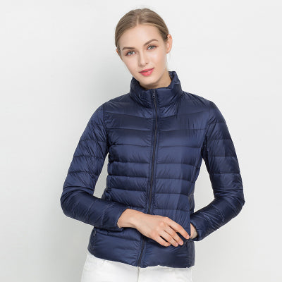 Warm women's puffer jacket: lightweight, quilted design, and protective stand collar. Ideal for winter fashion.
