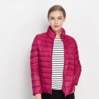 Stylish women's quilted puffer jacket with stand collar, offering warmth and sleek outerwear for colder weather.