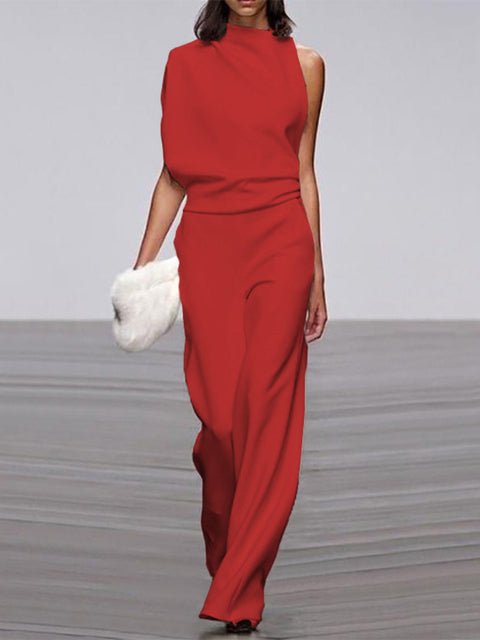 Close-up of elegant sleeveless neckline and strap detail on women's wide-leg open-back jumpsuit.
