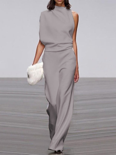 Back view of women's elegant open-back sleeveless jumpsuit with flowing wide legs, perfect for summer.
