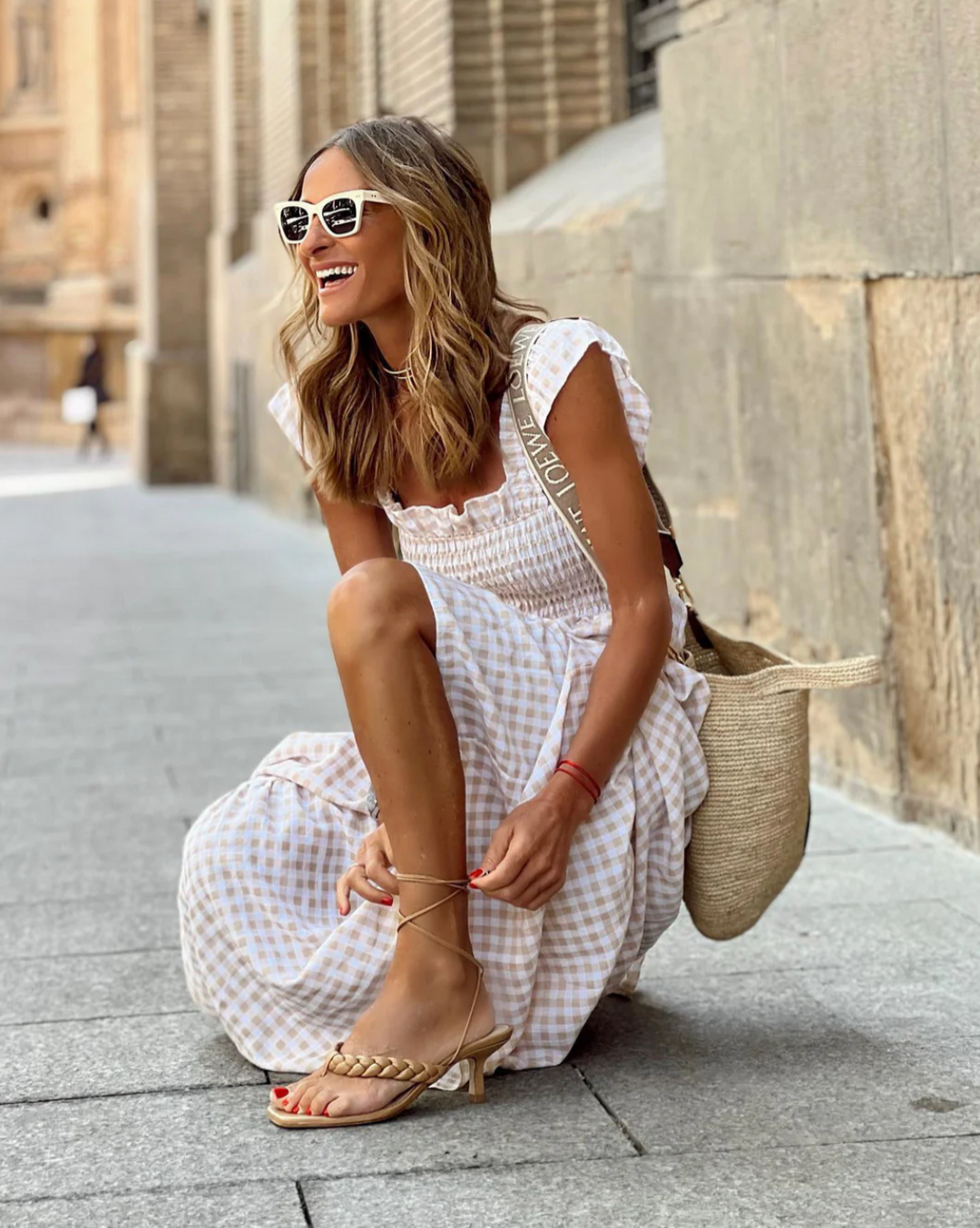 Flowy women's smocked gingham maxi dress, ideal for comfortable vacation wear or a casual summer day.