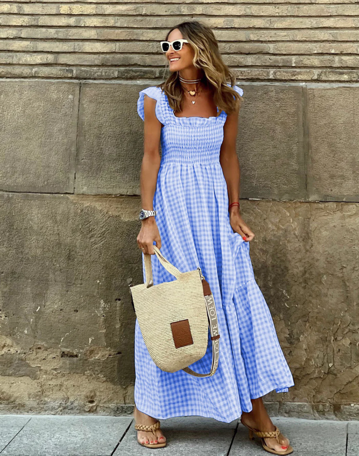 Lightweight women's gingham maxi dress, smocked for comfort with ruffle sleeves. Perfect flowy summer vacation wear.