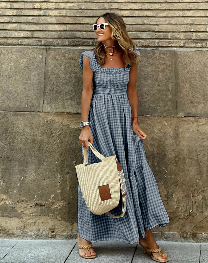 Women's smocked gingham maxi dress with ruffle sleeves, a stylish and comfortable long dress for summer.