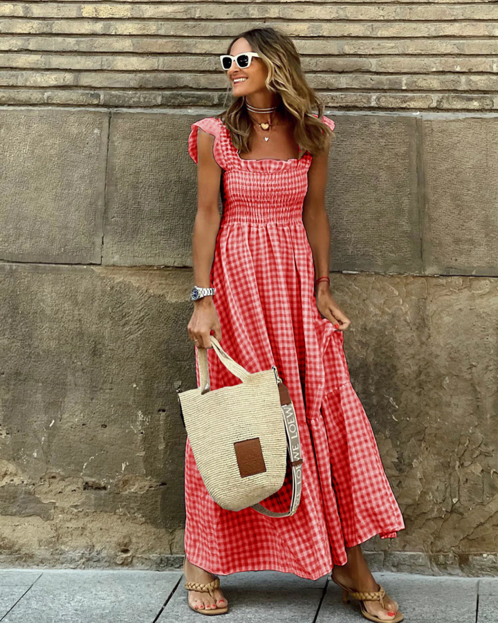 Elegant women's smocked gingham maxi dress, featuring ruffle sleeves for a chic, long summer fashion look.