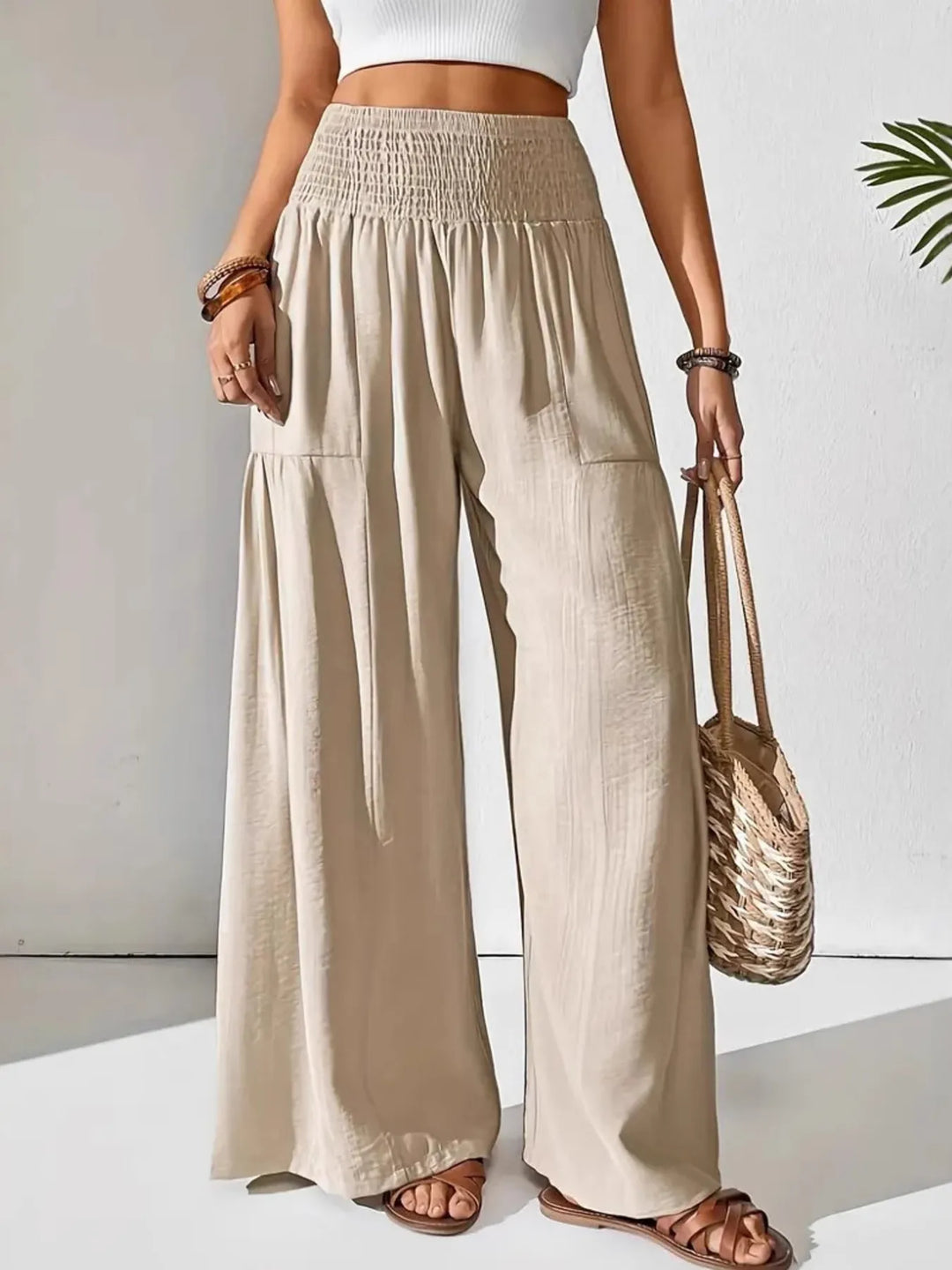 Women's smocked waist wide leg pants, comfortable & flowy, ideal for summer casual wear and travel.