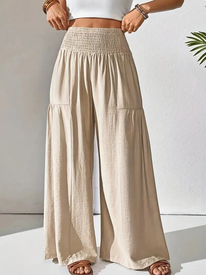 Flowy wide leg pants for women with smocked high waist, perfect for casual summer style and comfort.