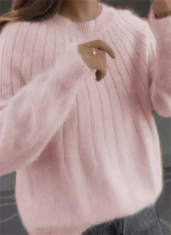 Close-up of women's Sofie soft cashmere knit sweater, showing cozy texture. Perfect elegant fall/winter jumper.