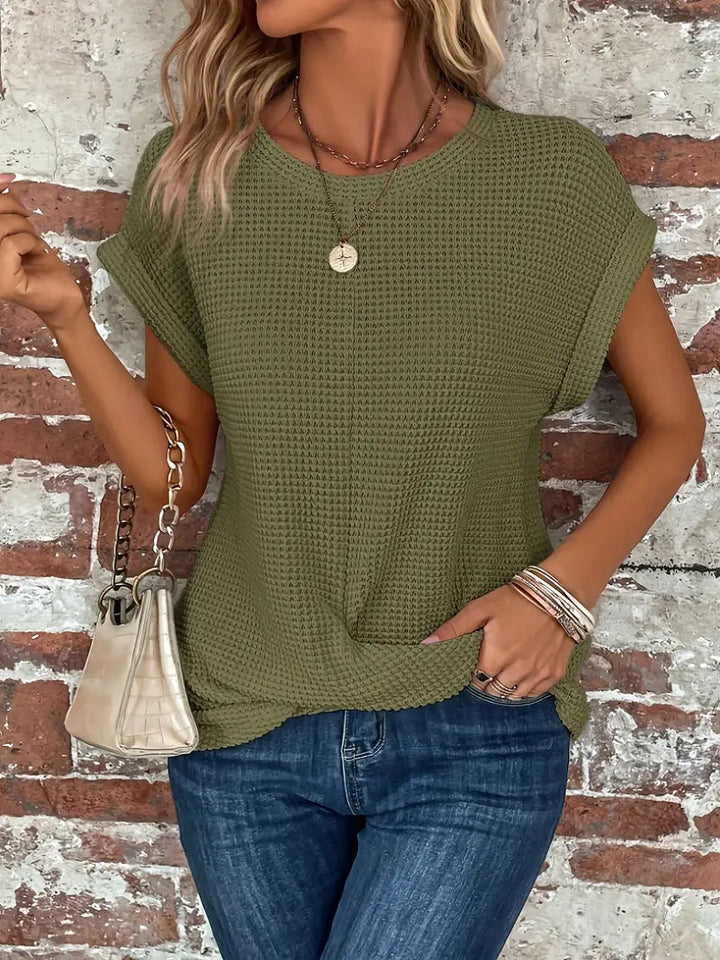 Versatile women's waffle knit top with a comfortable, relaxed fit and soft texture.
