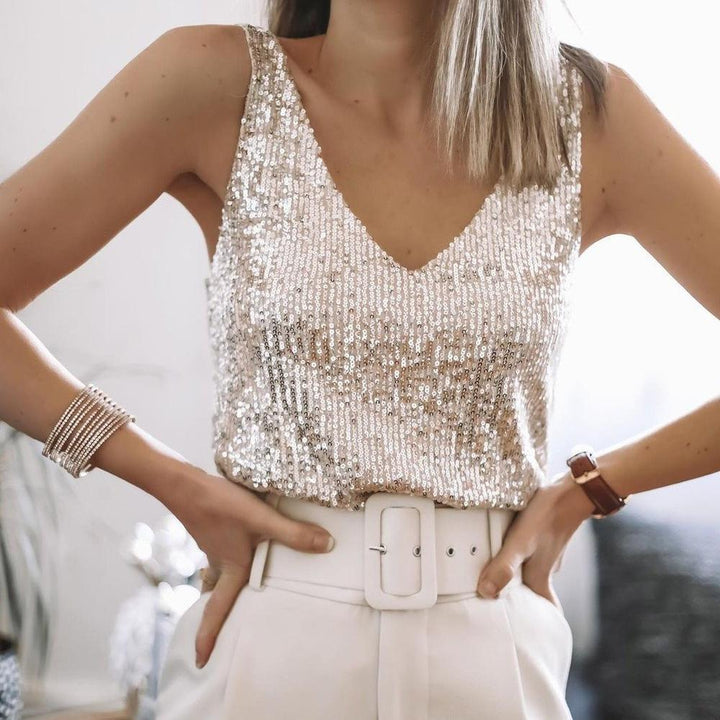 Close-up of a glamorous beige sequin top with delicate spaghetti straps. Shimmering women's party wear, Liora collection.