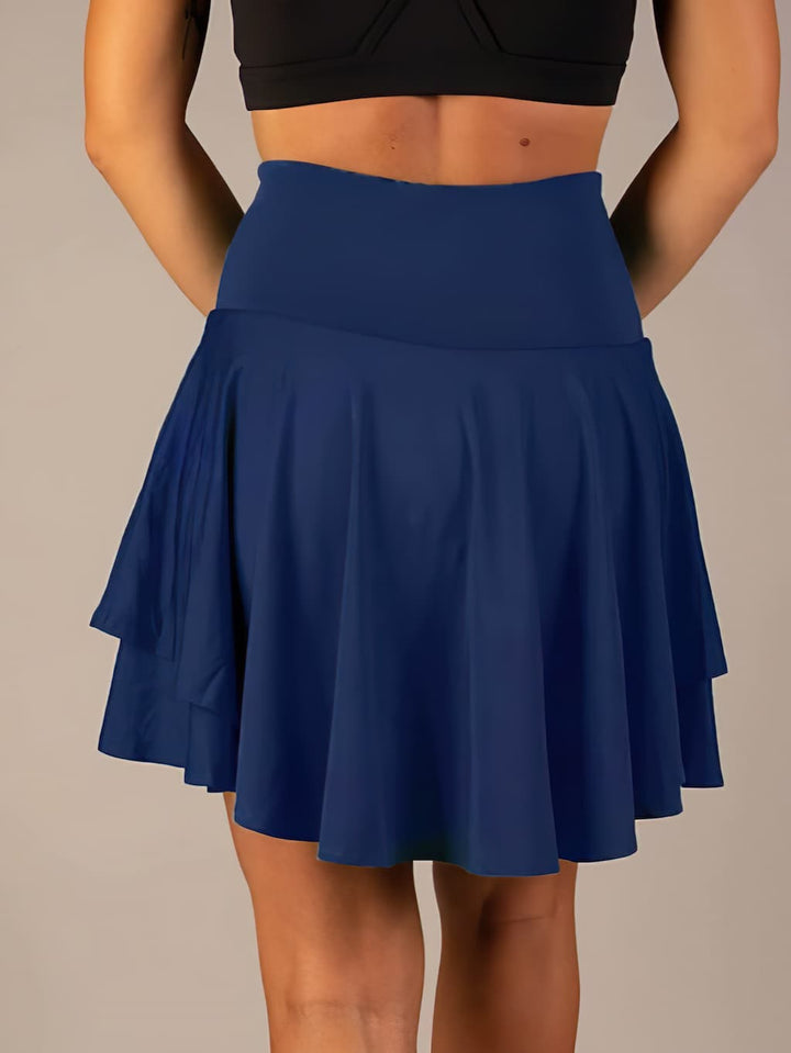 Comfortable women's athletic skirt for tennis, gym, and training, featuring built-in shorts.