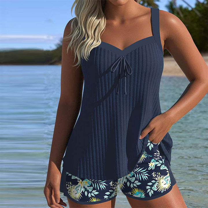 Women's striped tankini swimsuit with matching beach shorts, perfect for summer vacation.