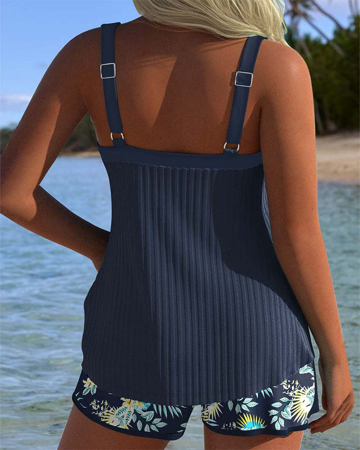 Modest two-piece striped tankini and shorts set for women, ideal for beach or pool wear.