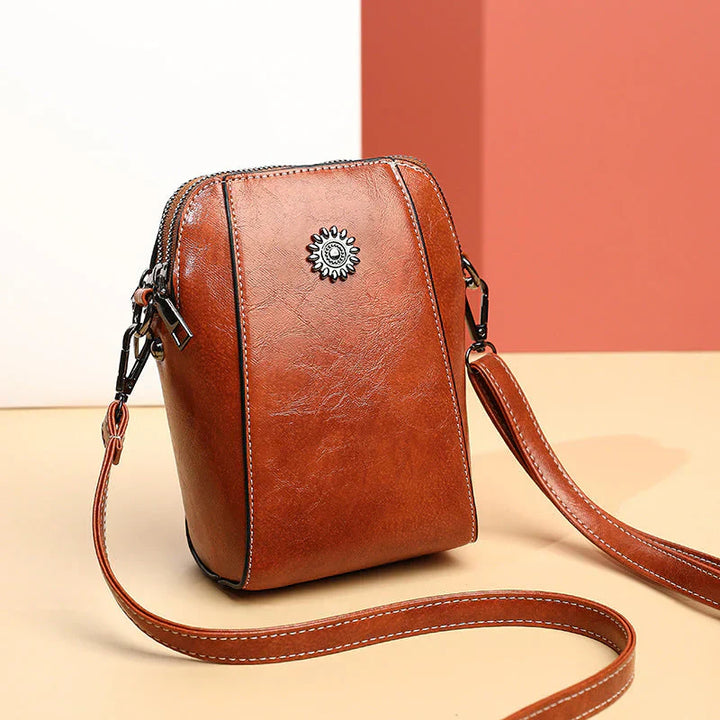 Green women's versatile leather shoulder bag, a stylish accessory for everyday use, with adjustable strap.
