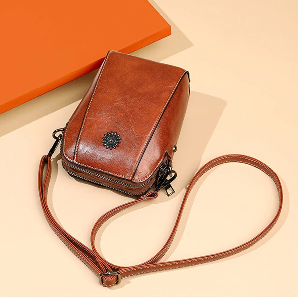 Modern black leather shoulder bag for women, sleek design, versatile for work or casual outings.