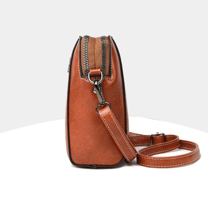 Everyday essential brown leather shoulder bag, a stylish and practical women's accessory with adjustable strap.