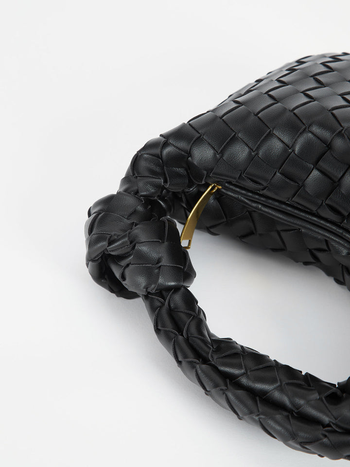 Stylish braided handbag for women, featuring a trendy knot handle and textured finish.
