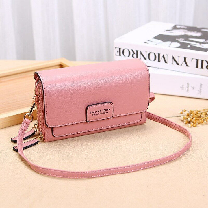 Sophisticated women's faux leather crossbody bag, includes a practical organizational wallet.