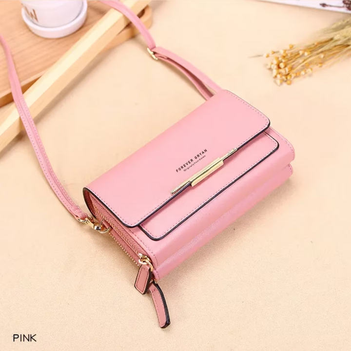 Elegant faux leather fashion accessory: a women's crossbody bag with a coordinating wallet.