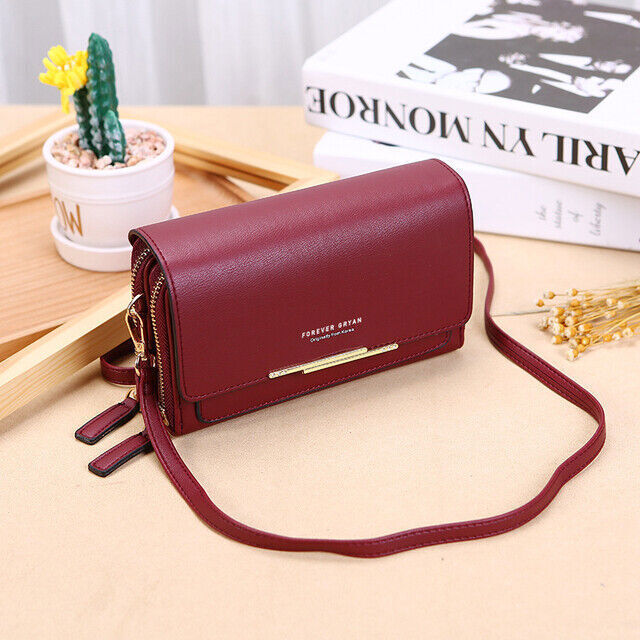Elegant black faux leather crossbody bag with integrated women's wallet, a chic fashion accessory.