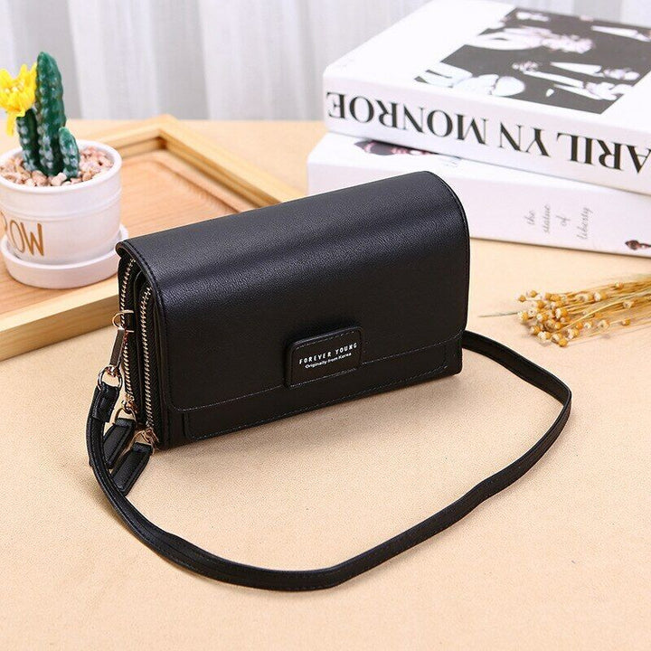 Multi-functional faux leather travel wallet and matching shoulder bag for women.