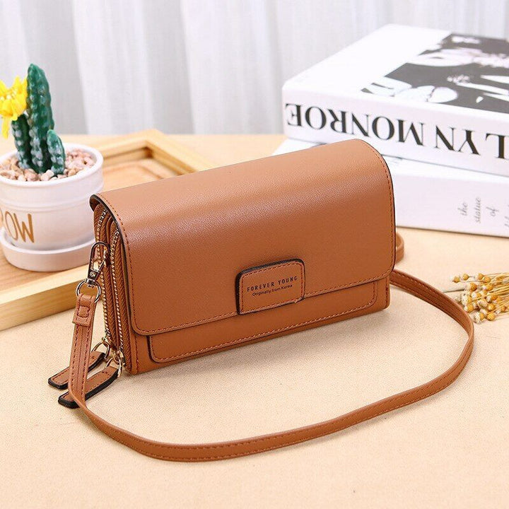 Chic faux leather crossbody bag for women, featuring a secure wallet compartment.