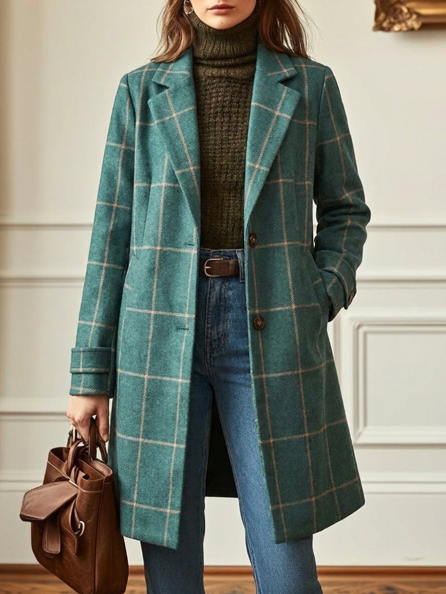 Women's stylish green checkered trench coat with wide lapel. Long, elegant outerwear for fall and winter fashion.