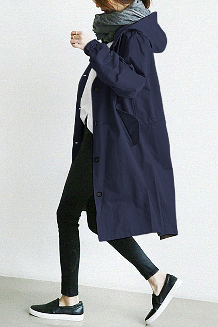 Close-up of the hood & collar on a women's hooded waterproof trench coat. Stylish, lightweight rain jacket.